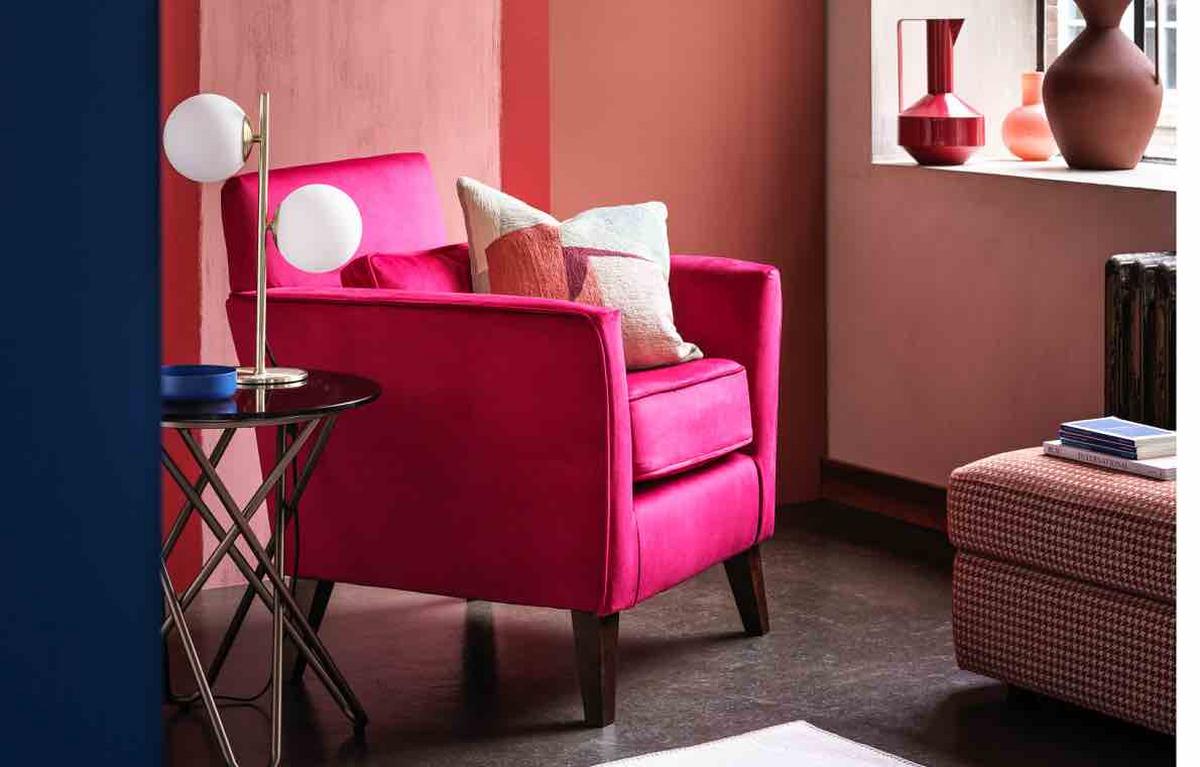 Hot pink accent chair in a retro-style room